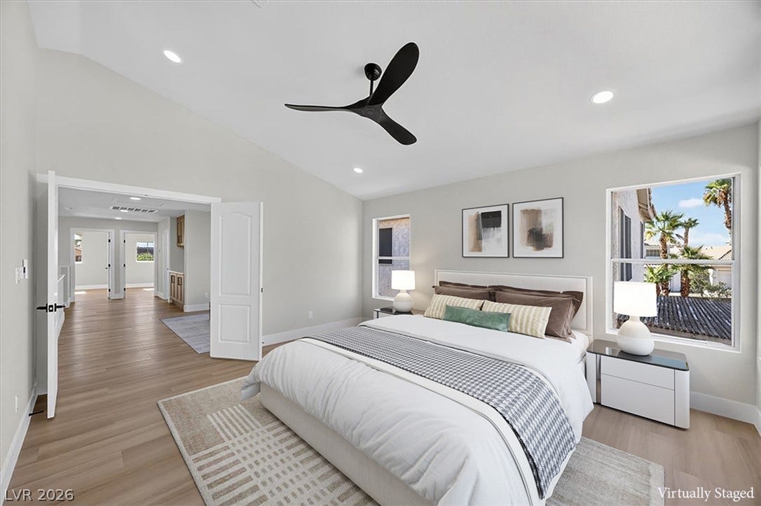136 Villaggio Street, Henderson, NV 89074 Vaulted ceilings and handsome wood-style flooring elevate this comfortable bedroom suite.
