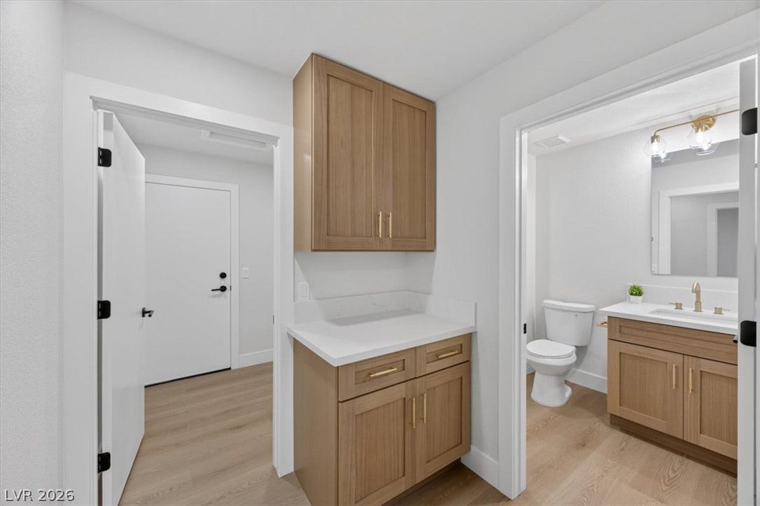 A well-appointed powder room features a sleek vanity and modern fixtures.