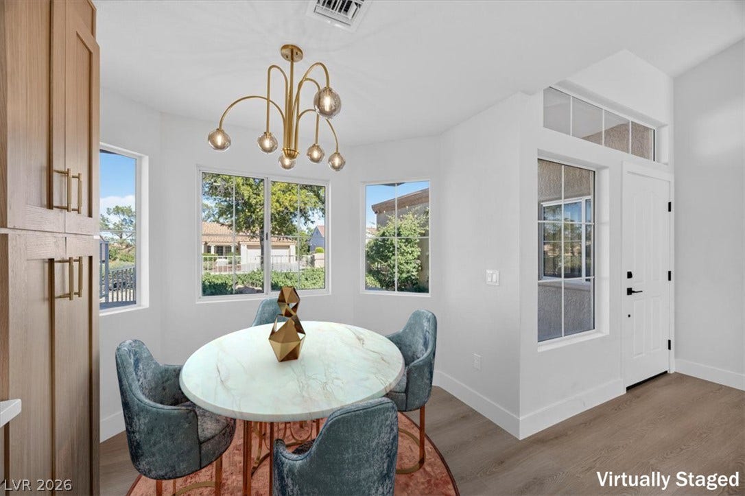 A refined dining area boasts plentiful natural light and modern overhead lighting.