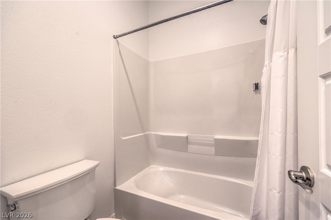 Convenient Jack and Jill Bathroom Connecting the Secondary Bedrooms with Dual Sinks, Tub/Shower Combination, and Tile Flooring