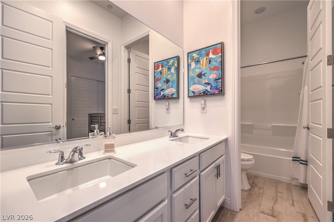 Convenient Jack and Jill Bathroom Connecting the Secondary Bedrooms with Dual Sinks, Tub/Shower Combination, and Tile Flooring