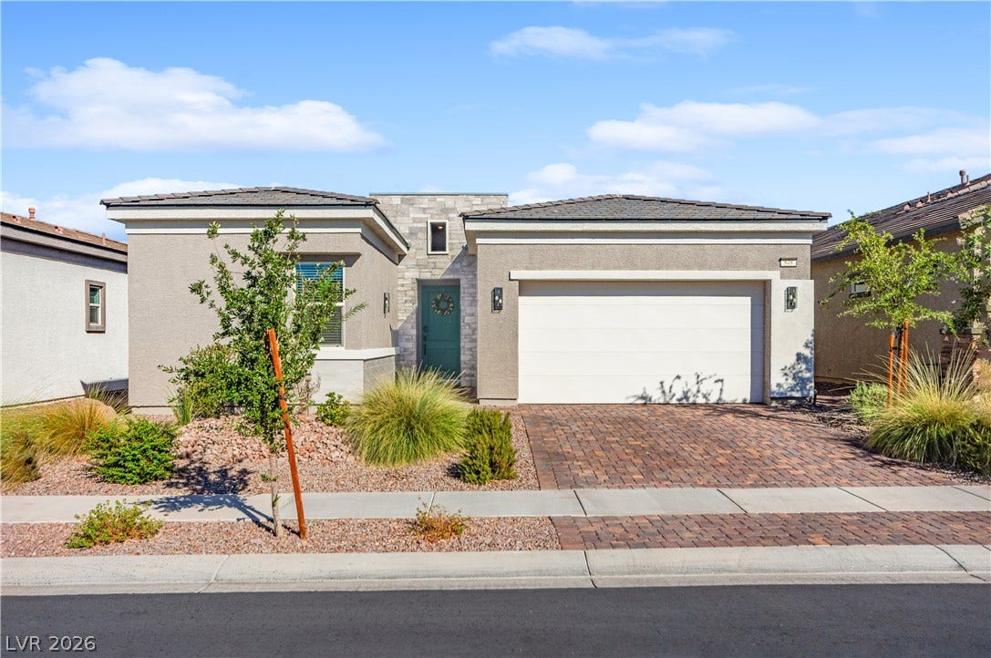 848 Purser Street, Henderson, NV 89011 Clean lines and stone accents define this modern single-story exterior with a paver driveway.
