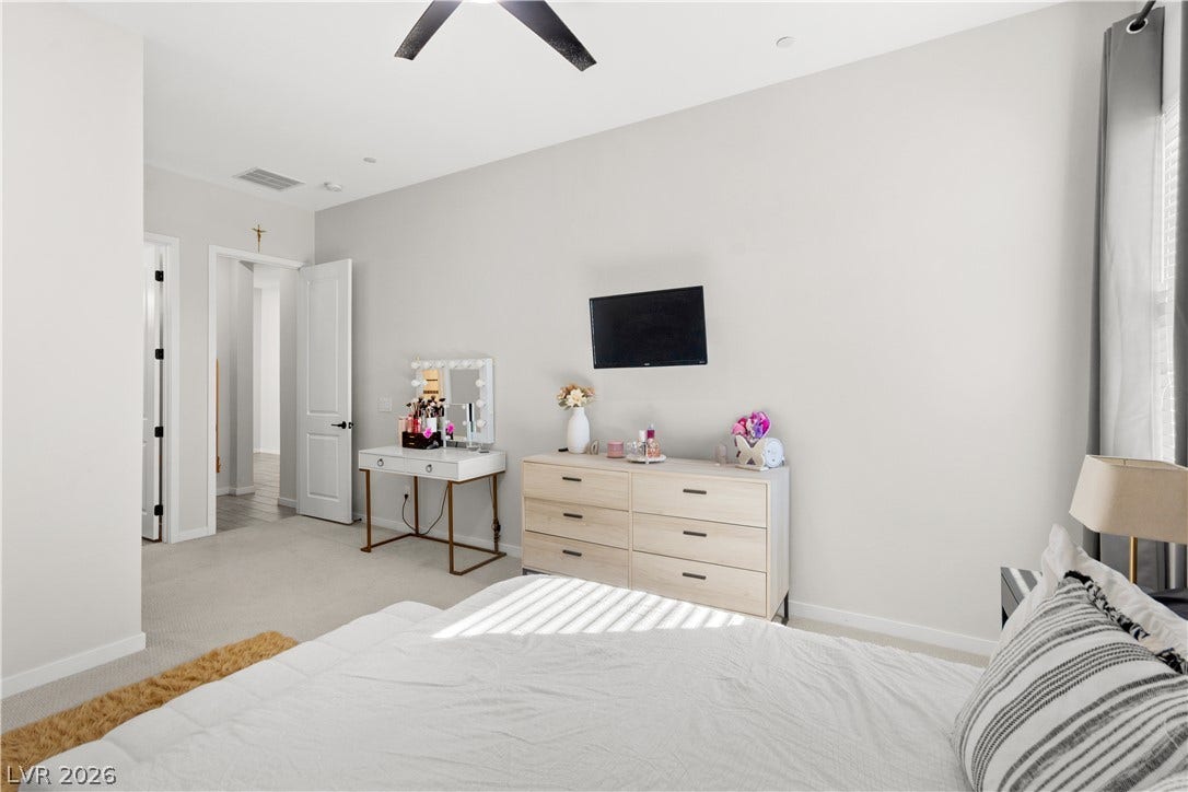 848 Purser Street, Henderson, NV 89011 High ceilings and soft neutral walls enhance this serene bedroom retreat.