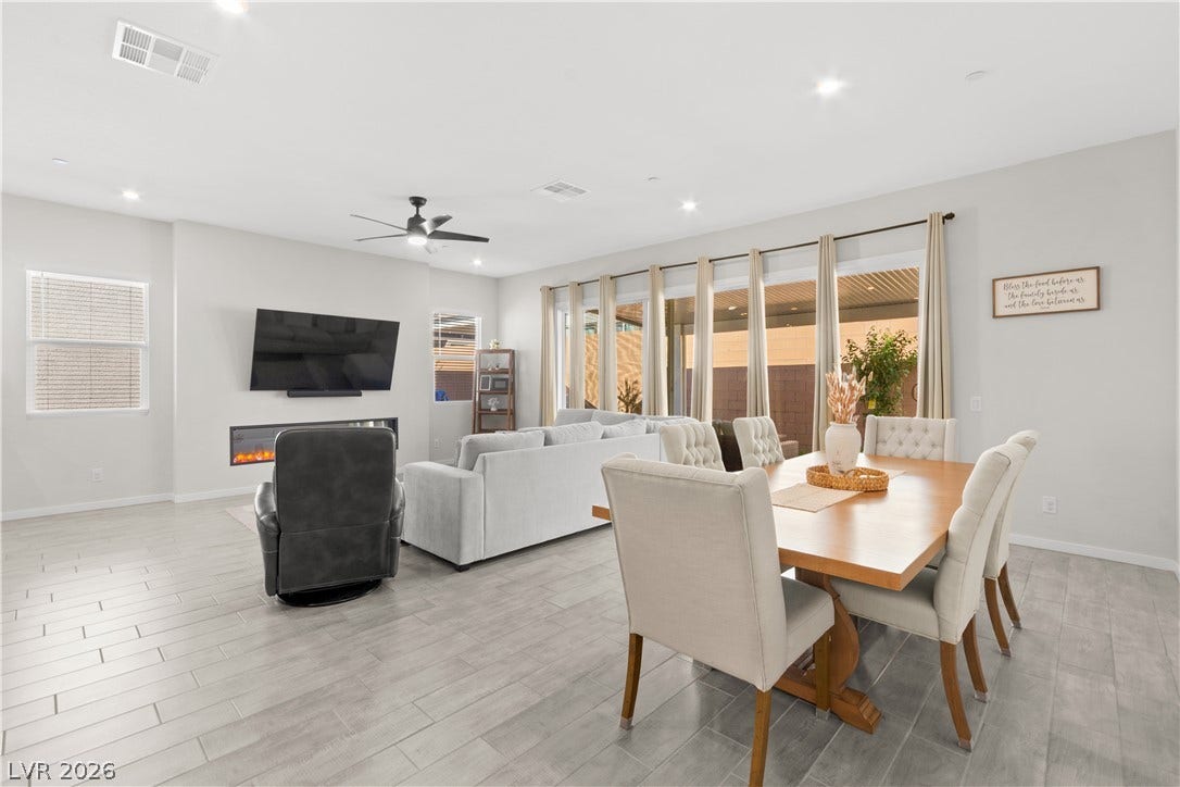 848 Purser Street, Henderson, NV 89011 An open floorplan seamlessly connects the living and dining areas over sleek wood-look tile flooring.