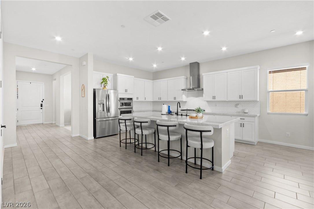848 Purser Street, Henderson, NV 89011 An open kitchen layout centers around a large island under recessed lighting.