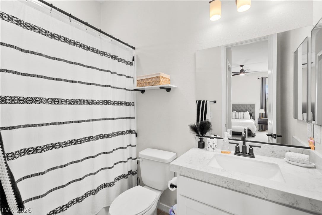 848 Purser Street, Henderson, NV 89011 An elegant stone counter highlights this modern full bathroom with a large mirror.