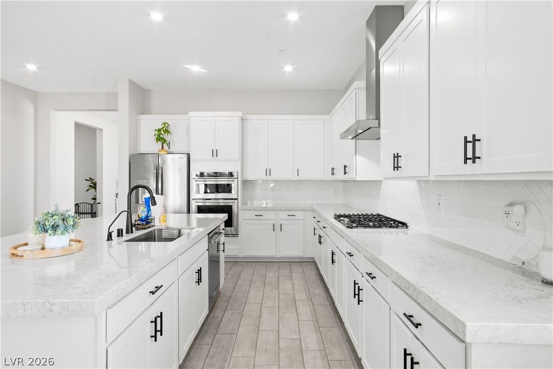 848 Purser Street, Henderson, NV 89011 Sleek modern cabinetry and stone countertops anchor this bright, open kitchen space.