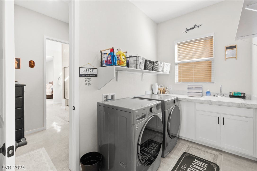 848 Purser Street, Henderson, NV 89011 An organized laundry room features modern washing appliances, durable countertops, and built-in cabinetry.