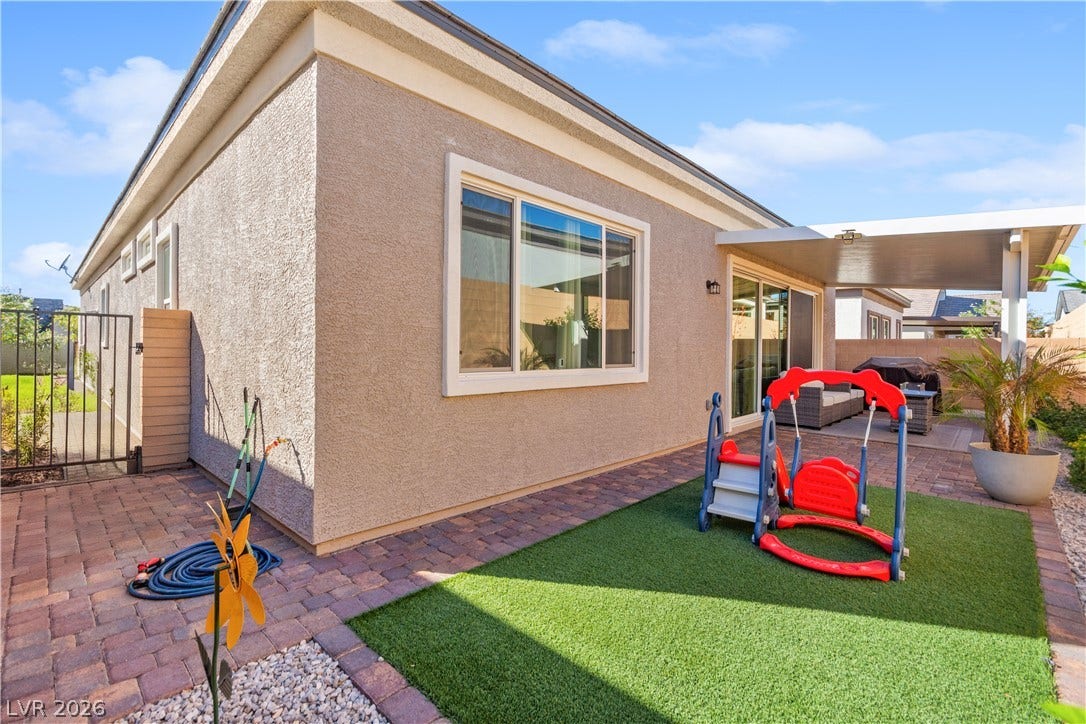 848 Purser Street, Henderson, NV 89011 Brick paver patio areas complement the low-maintenance synthetic turf in this tidy backyard space.