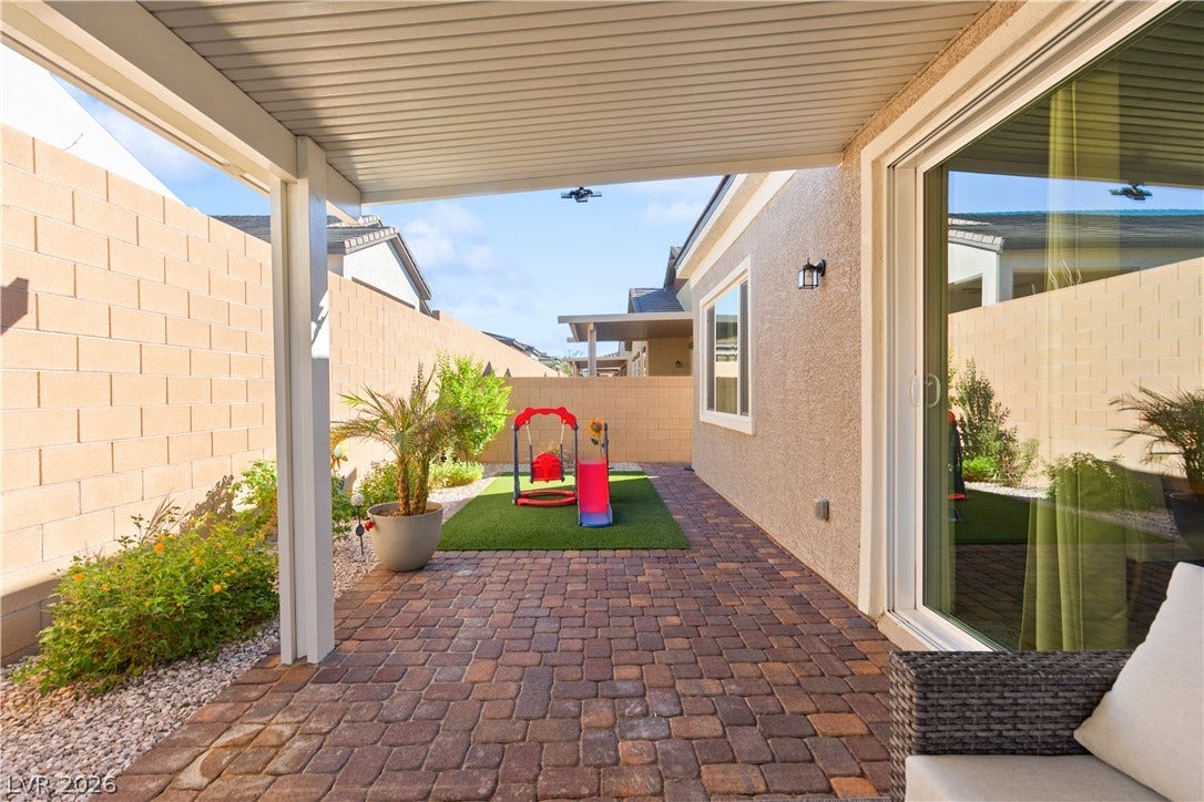 848 Purser Street, Henderson, NV 89011 A covered patio lined with brick pavers transitions seamlessly to the private backyard area.