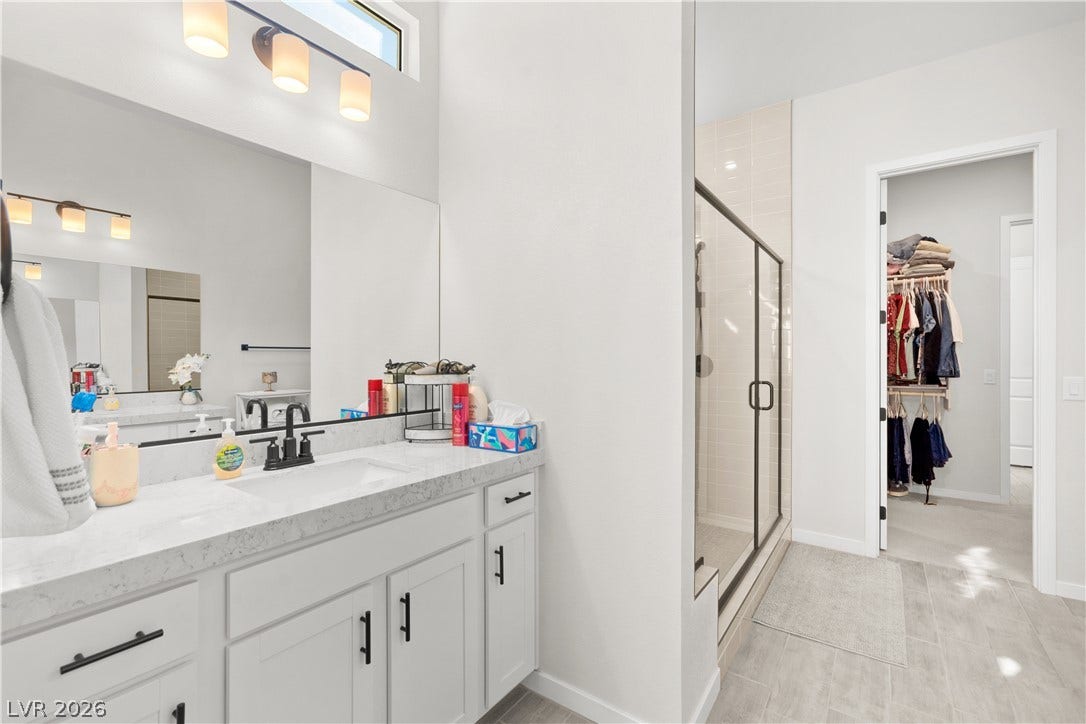 848 Purser Street, Henderson, NV 89011 A modern bathroom features clean lines, tiled floors, and access to a walk-in closet.