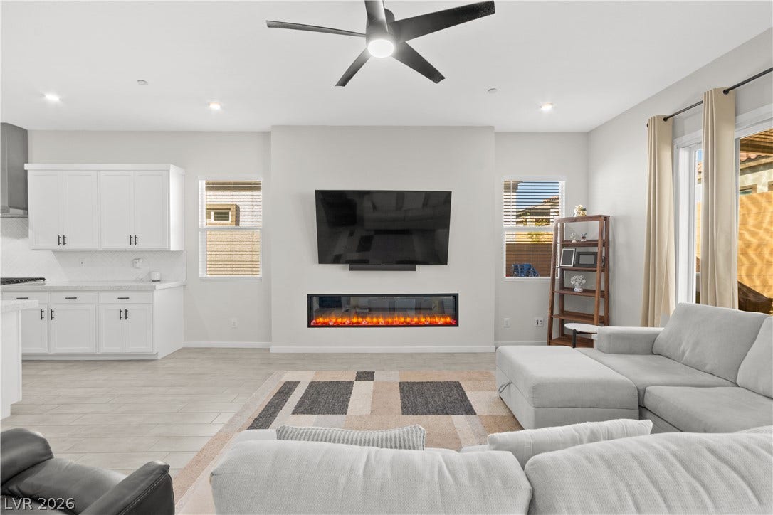 848 Purser Street, Henderson, NV 89011 An open floorplan seamlessly connects the living space to a modern kitchen with white cabinetry.