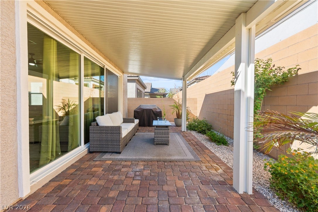 848 Purser Street, Henderson, NV 89011 Brick pavers and a protective overhead cover define this inviting outdoor living space.