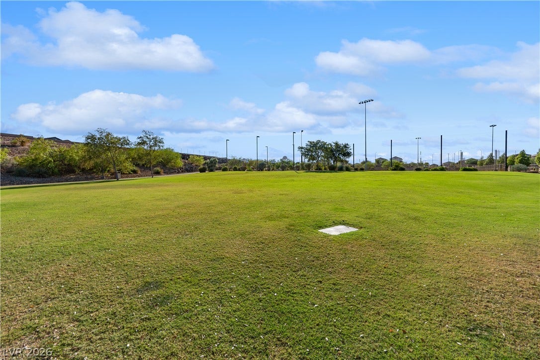 848 Purser Street, Henderson, NV 89011 A spacious green lawn stretches out under open skies within this peaceful community park.