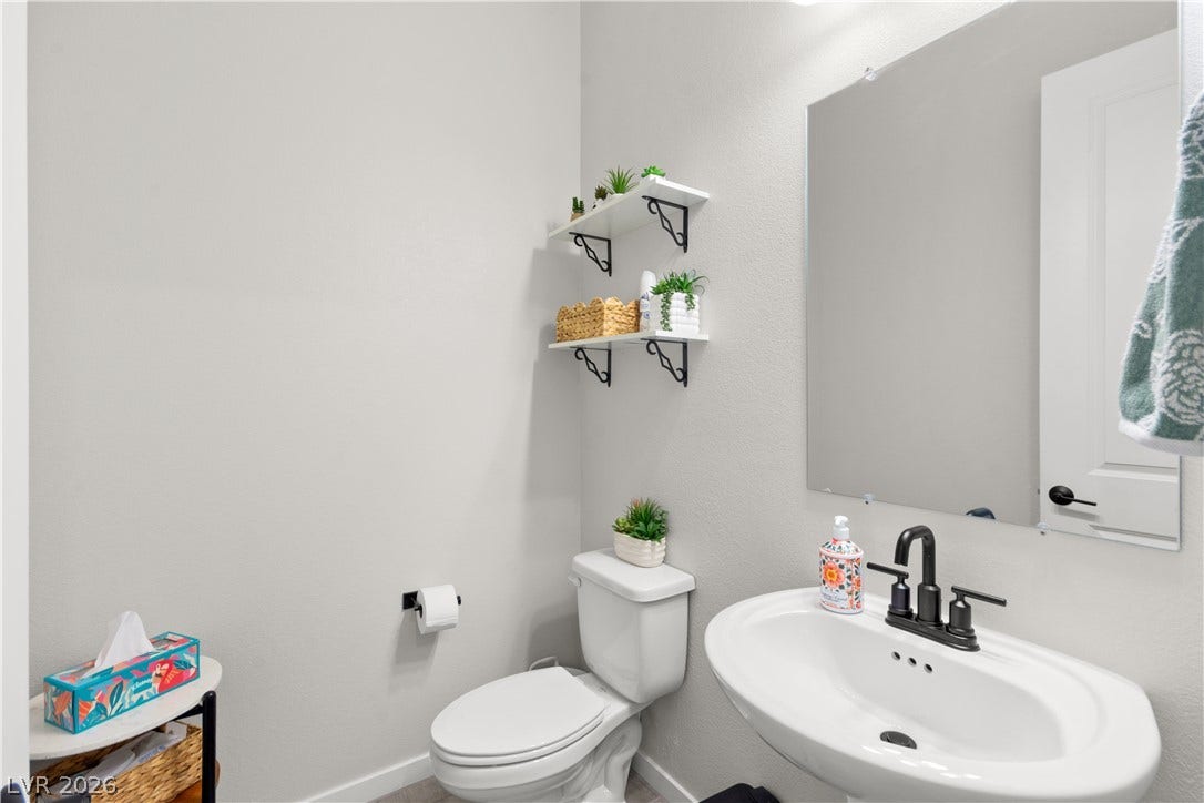 848 Purser Street, Henderson, NV 89011 Clean lines and classic fixtures define this simple powder room layout.