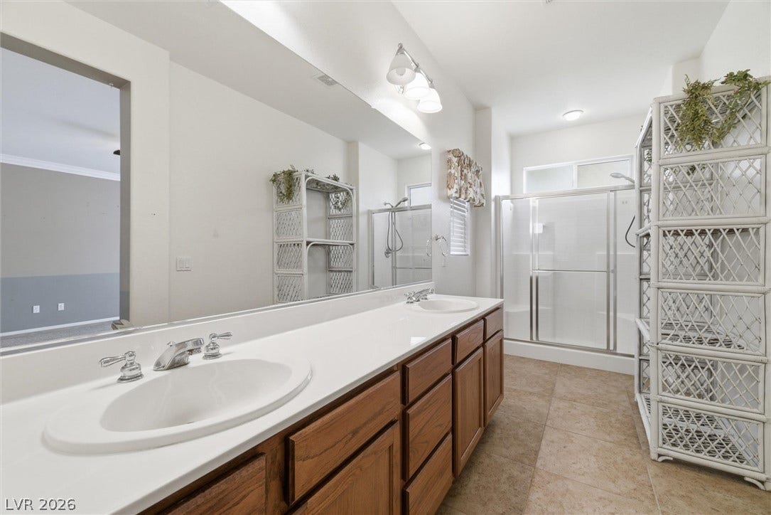 4911 S Castello Way, Pahrump, NV 89061 Clean lines and a spacious dual vanity define this comfortable bathroom.