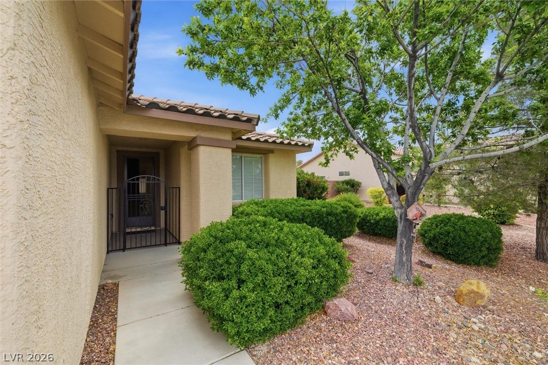 4911 S Castello Way, Pahrump, NV 89061 A welcoming front entry pathway is framed by manicured shrubs and desert landscaping.