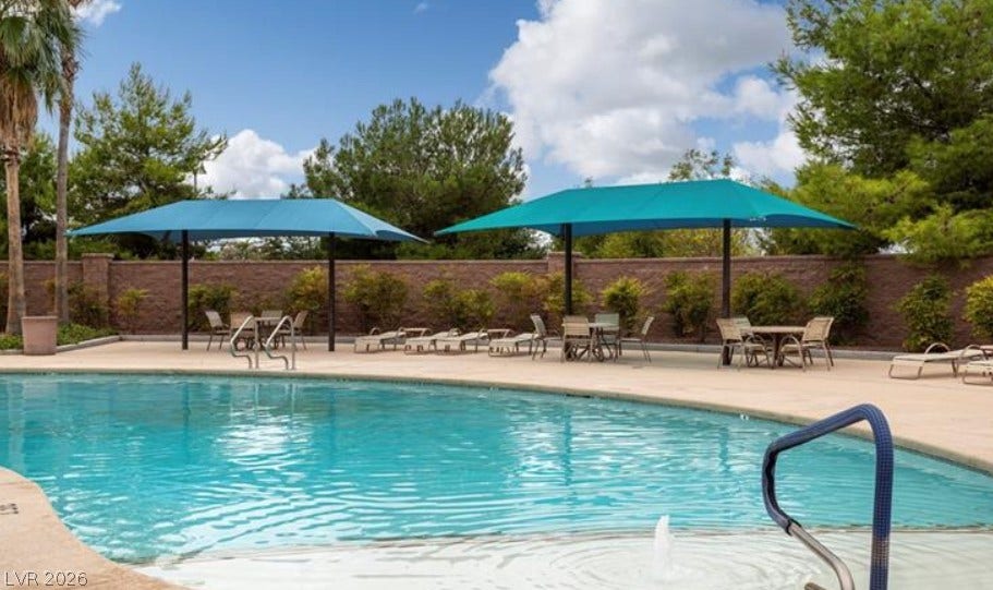 4911 S Castello Way, Pahrump, NV 89061 A refreshing community pool features a spacious concrete deck shaded by expansive blue canopies.