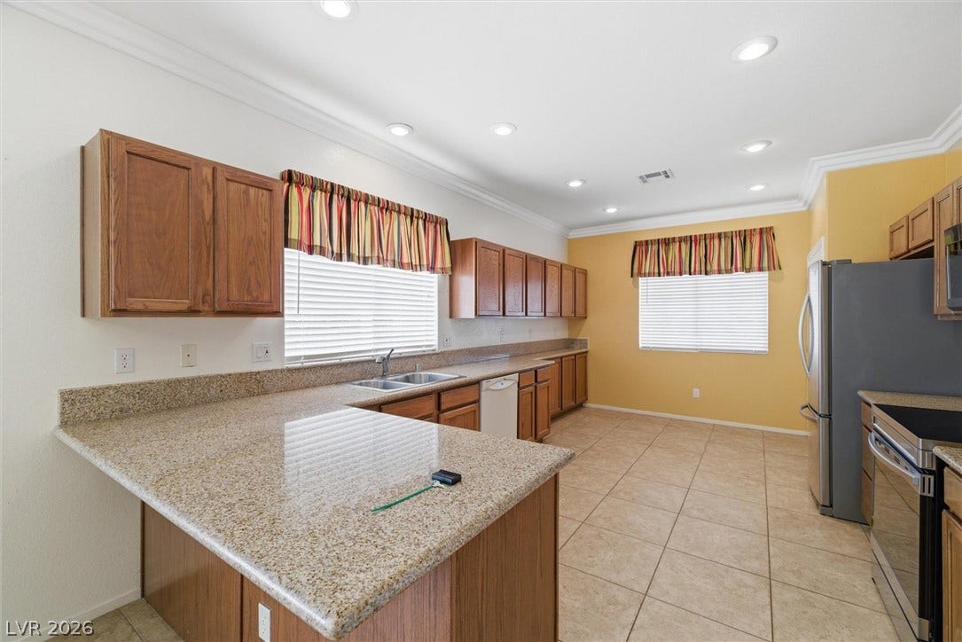 4911 S Castello Way, Pahrump, NV 89061 Gleaming granite countertops pair beautifully with warm wood cabinetry and durable tile flooring.
