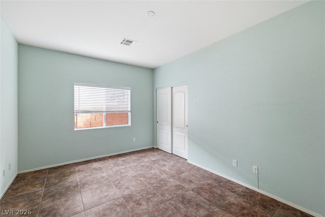 4911 S Castello Way, Pahrump, NV 89061 Tiled flooring and a sliding closet door define this versatile auxiliary bedroom space.
