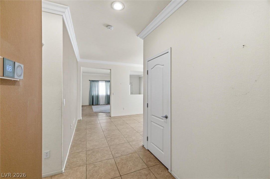 4911 S Castello Way, Pahrump, NV 89061 Tiled flooring and elegant crown molding guide guests through a welcoming hallway entry.