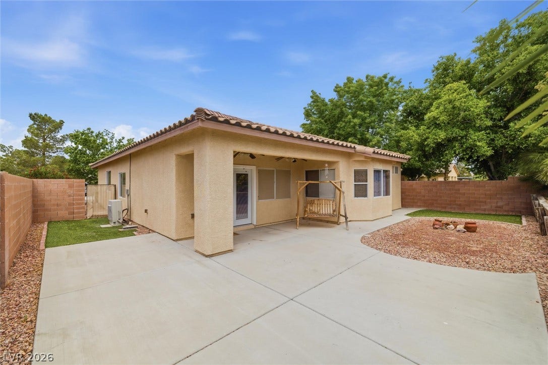 4911 S Castello Way, Pahrump, NV 89061 A spacious concrete patio meets low-maintenance desert landscaping under the shelter of a covered back porch.