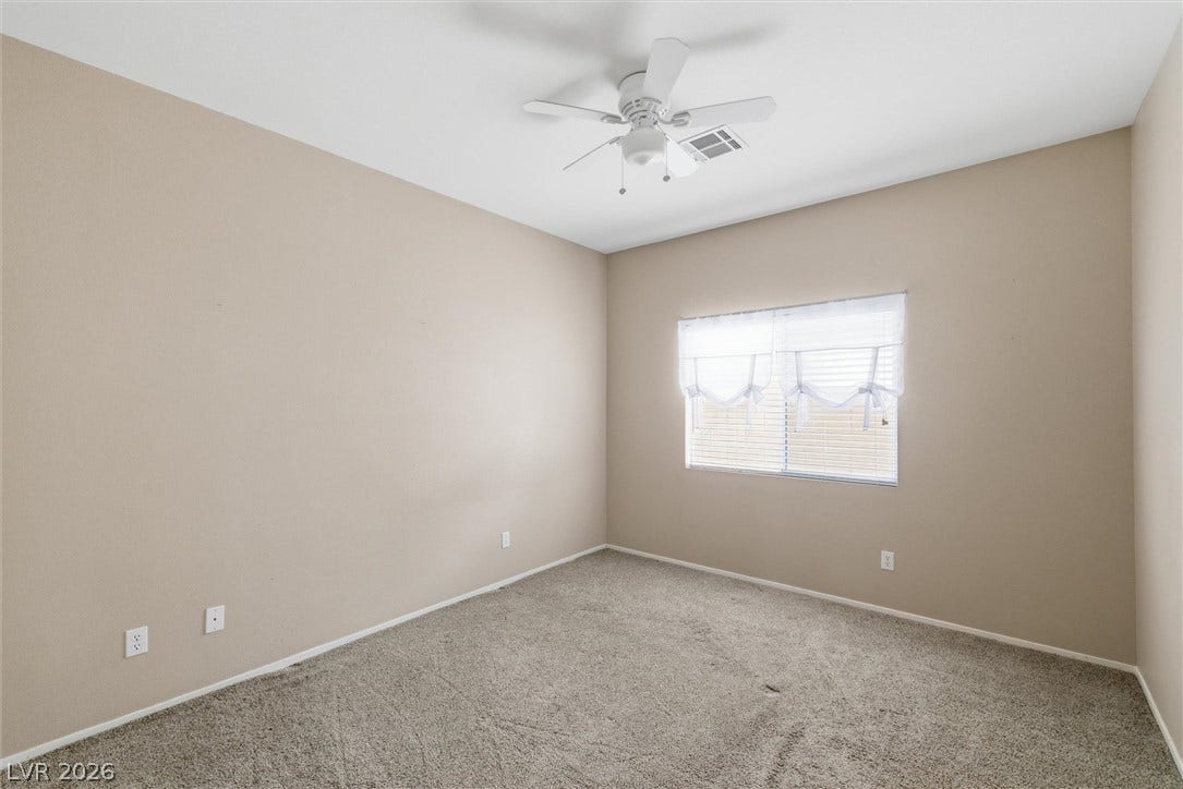 4911 S Castello Way, Pahrump, NV 89061 Soft carpeting pairs with neutral walls and an overhead light to create a comfortable space.