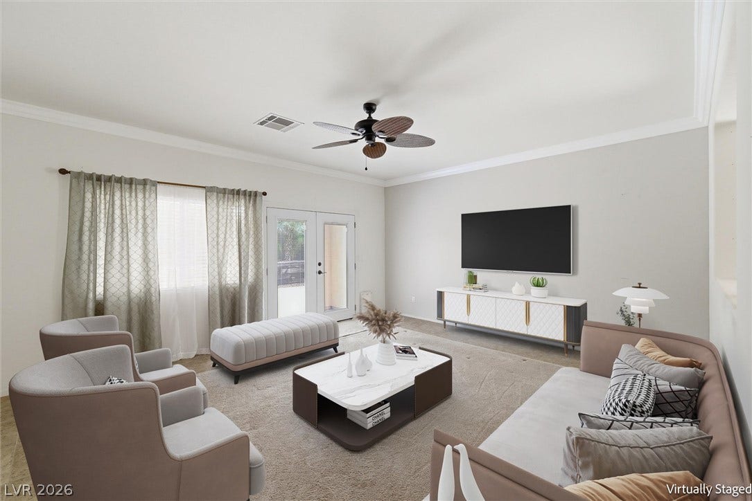4911 S Castello Way, Pahrump, NV 89061 Plush carpeting and elegant crown molding define this welcoming living space.