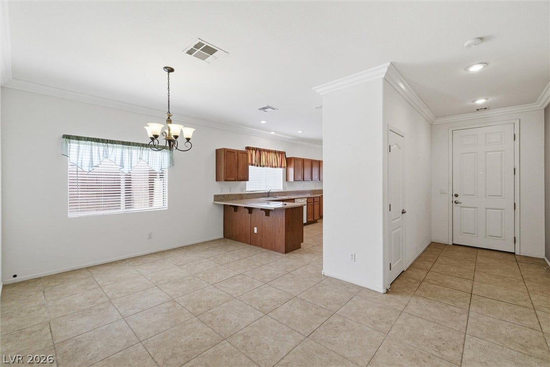 4911 S Castello Way, Pahrump, NV 89061 Crown molding frames the open-concept layout leading directly into a spacious kitchen.