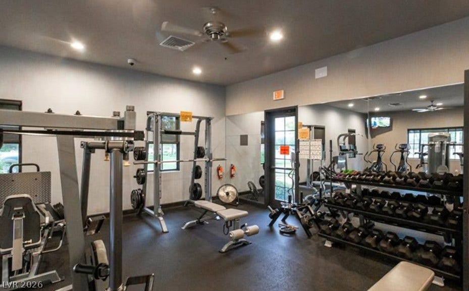 4911 S Castello Way, Pahrump, NV 89061 Mirrored walls and recessed lighting elevate this fully equipped fitness space.