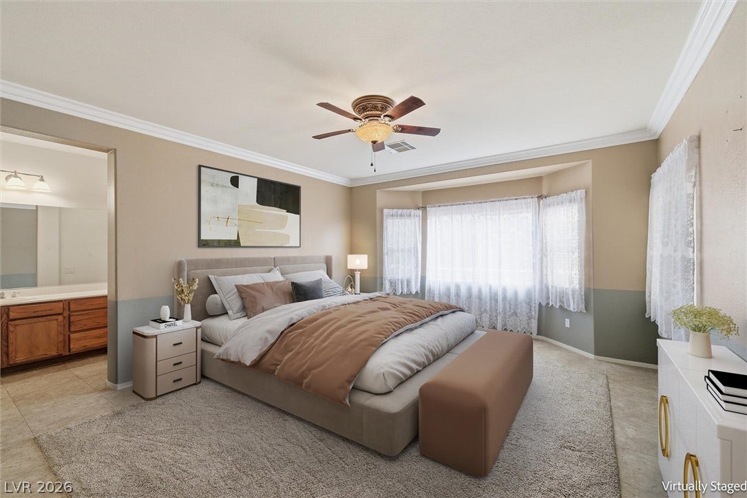 4911 S Castello Way, Pahrump, NV 89061 An elegant bay window highlights this bedroom, bordered by crown molding and tile flooring.