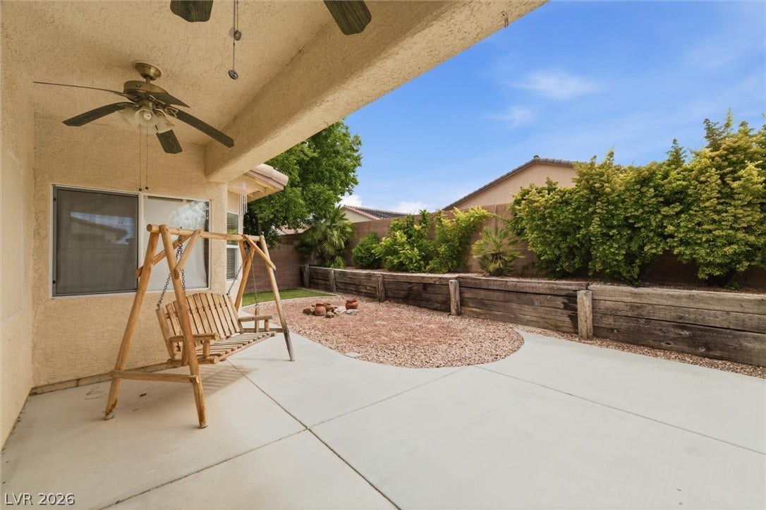 4911 S Castello Way, Pahrump, NV 89061 A spacious covered concrete patio overlooks a low-maintenance backyard enclosed by privacy fencing.
