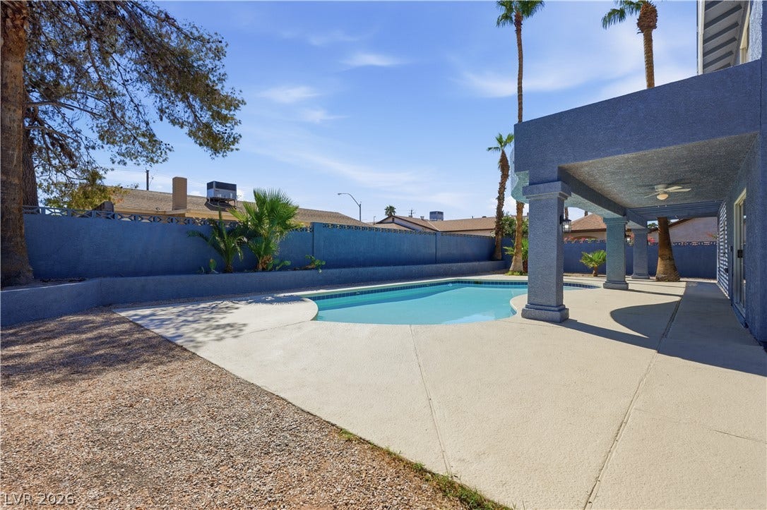 1707 Mapleton Lane, Las Vegas, NV 89119 An inviting backyard oasis features a sparkling in-ground pool and a spacious covered patio.
