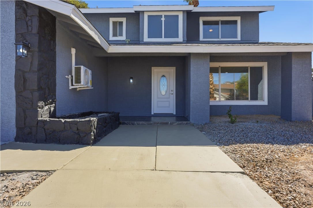 1707 Mapleton Lane, Las Vegas, NV 89119 A concrete walkway leads past stone accents to the recessed front entry of this multi-level home.