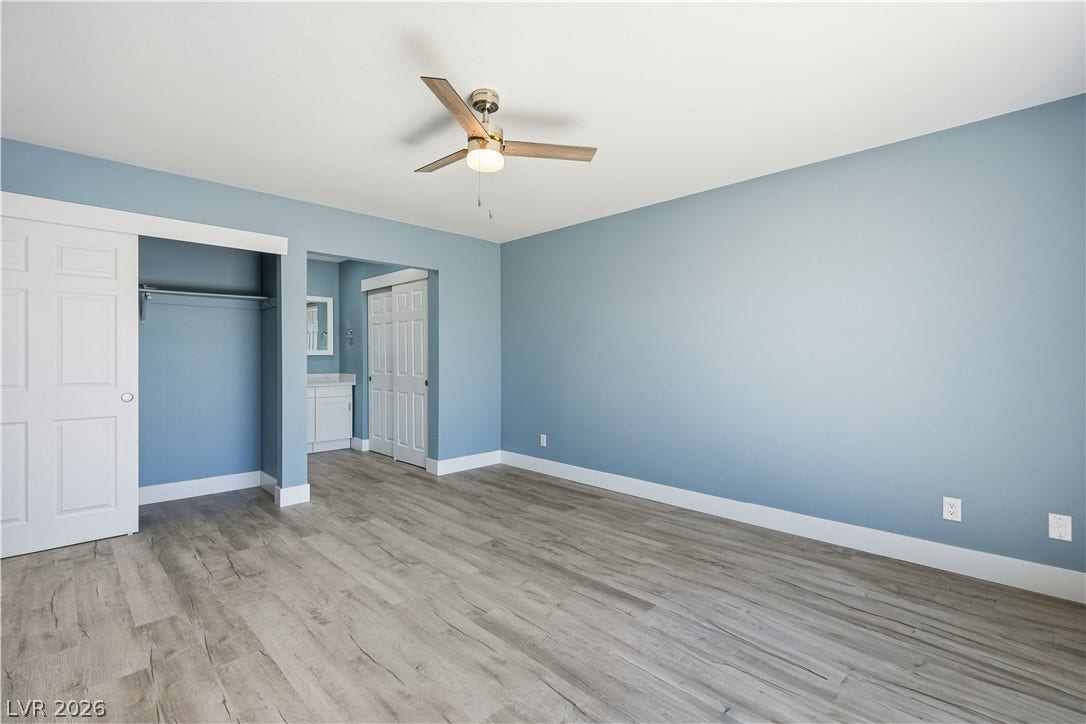 1707 Mapleton Lane, Las Vegas, NV 89119 Smooth wood-look flooring and crisp white trim enhance this bedroom.