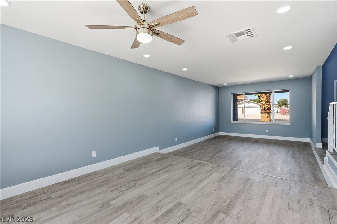 1707 Mapleton Lane, Las Vegas, NV 89119 Smooth wood-look flooring and crisp recessed lighting define this spacious open living area.