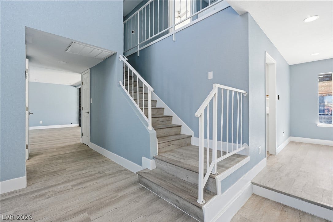 1707 Mapleton Lane, Las Vegas, NV 89119 A centrally located staircase connects open living areas finished with durable wood-look flooring.