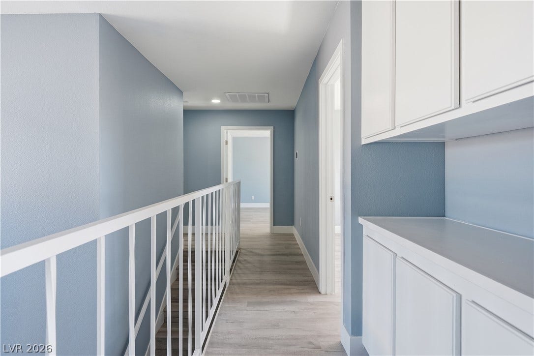 1707 Mapleton Lane, Las Vegas, NV 89119 Clean lines and smooth flooring define this light-filled hallway landing with built-in cabinetry storage.