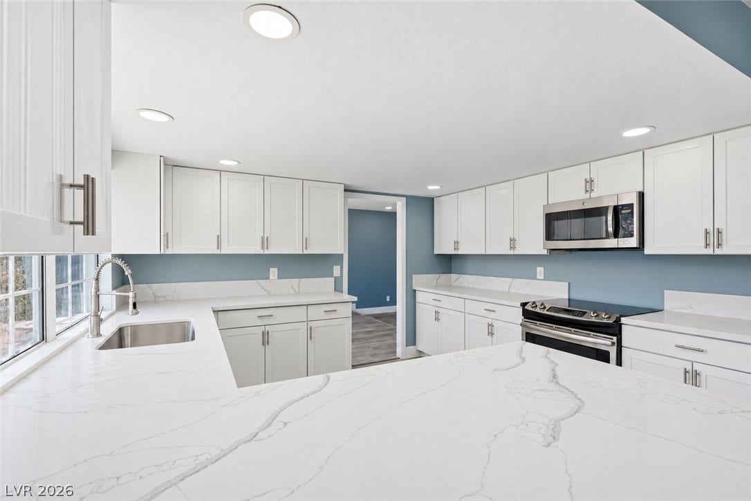 1707 Mapleton Lane, Las Vegas, NV 89119 Sleek stone countertops and classic shaker cabinetry define this modern culinary space.