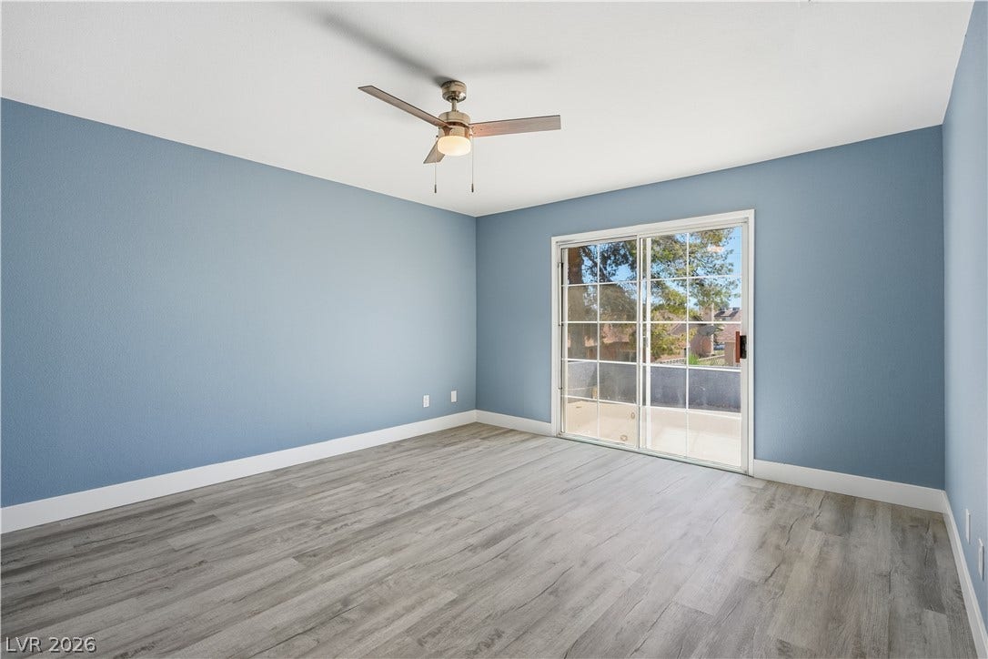 1707 Mapleton Lane, Las Vegas, NV 89119 Sliding glass doors open to a private balcony from this spacious secondary bedroom.