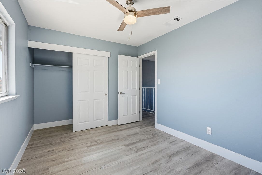 1707 Mapleton Lane, Las Vegas, NV 89119 Smooth wood-textured flooring complements the clean lines of this modern bedroom design.