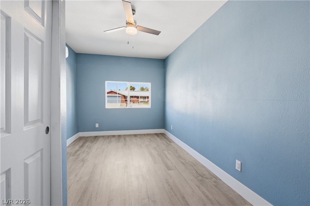 1707 Mapleton Lane, Las Vegas, NV 89119 Smooth wood-plank flooring pairs with a classic multi-lite window in this versatile space.