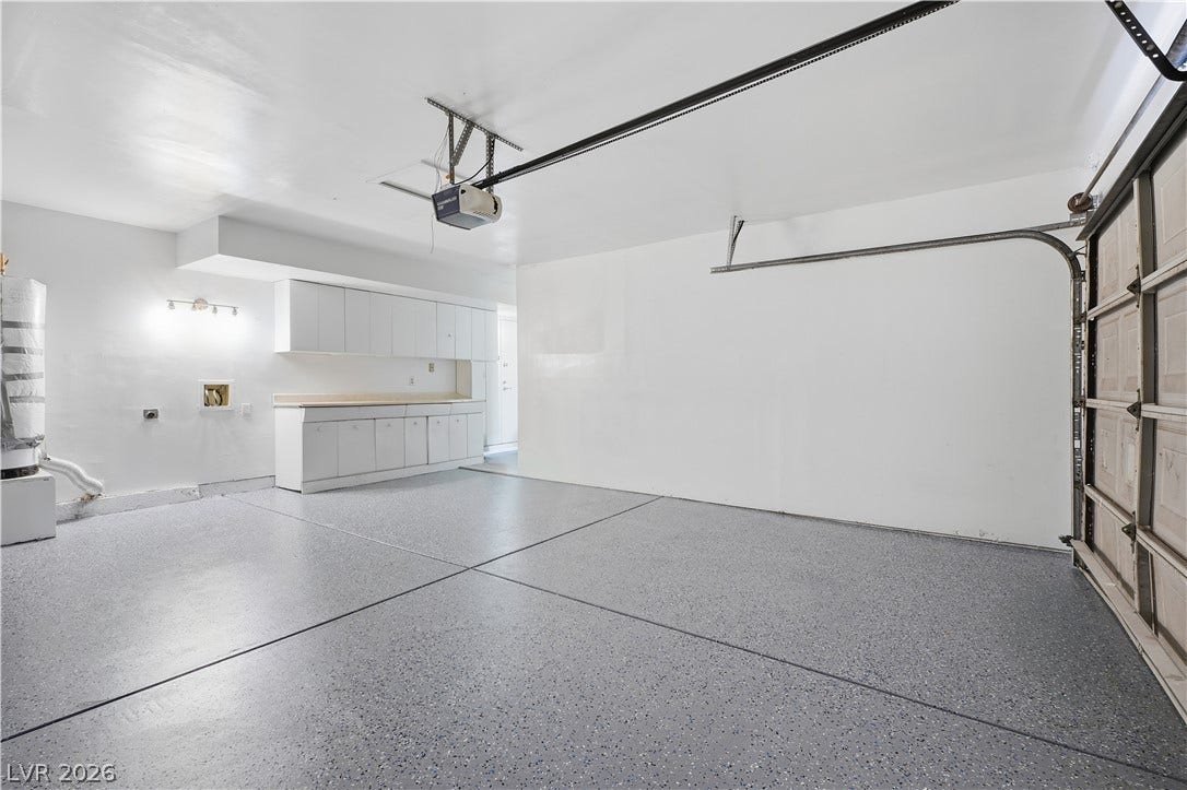 1707 Mapleton Lane, Las Vegas, NV 89119 Finished epoxy flooring and extensive built-in cabinetry elevate this functional utility space.
