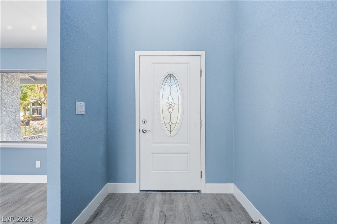 1707 Mapleton Lane, Las Vegas, NV 89119 High ceilings and durable wood-look flooring frame this welcoming entryway.