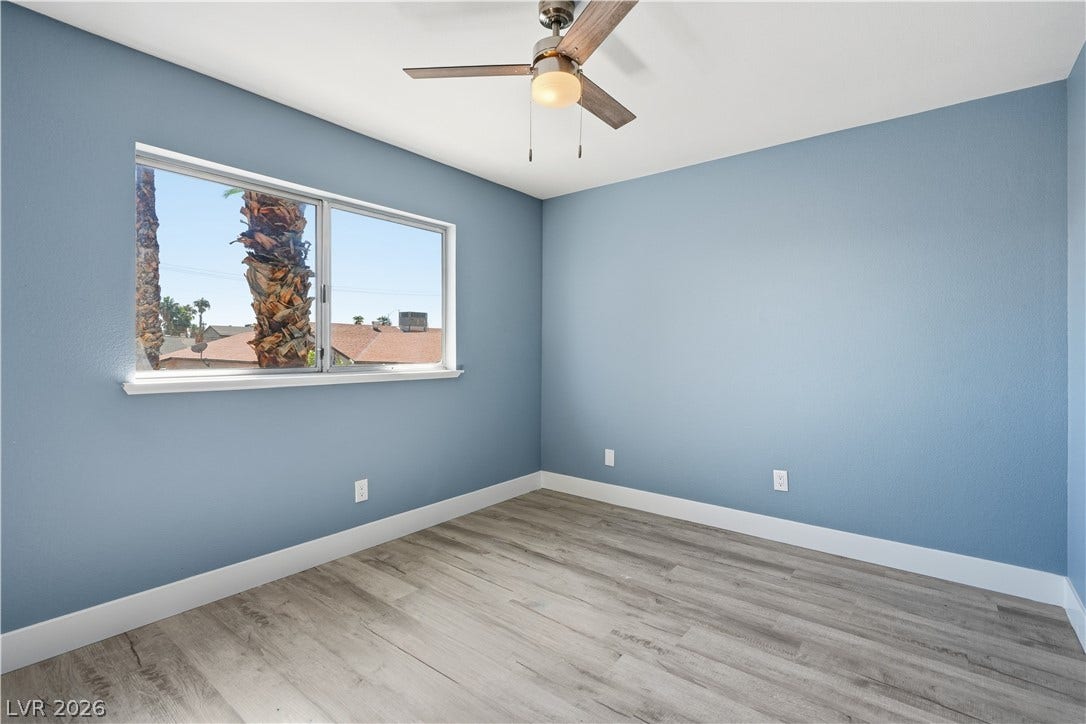 1707 Mapleton Lane, Las Vegas, NV 89119 Smooth wood-look flooring and a wide picture window create a serene, welcoming ambiance.