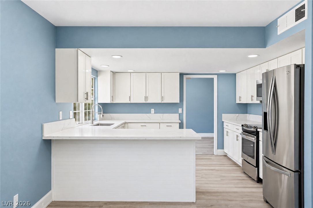 1707 Mapleton Lane, Las Vegas, NV 89119 Gleaming stone countertops and stainless steel appliances anchor this beautifully updated, open-concept kitchen.