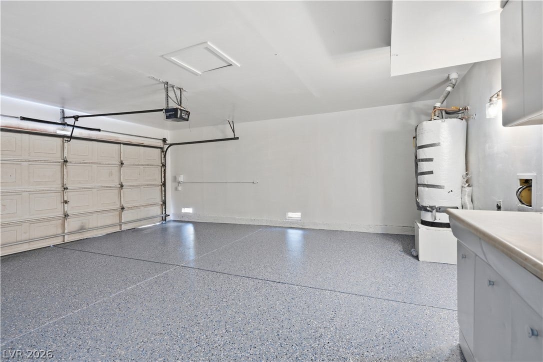 1707 Mapleton Lane, Las Vegas, NV 89119 An immaculate multi-car garage features a durable epoxy-coated concrete floor and utility area.