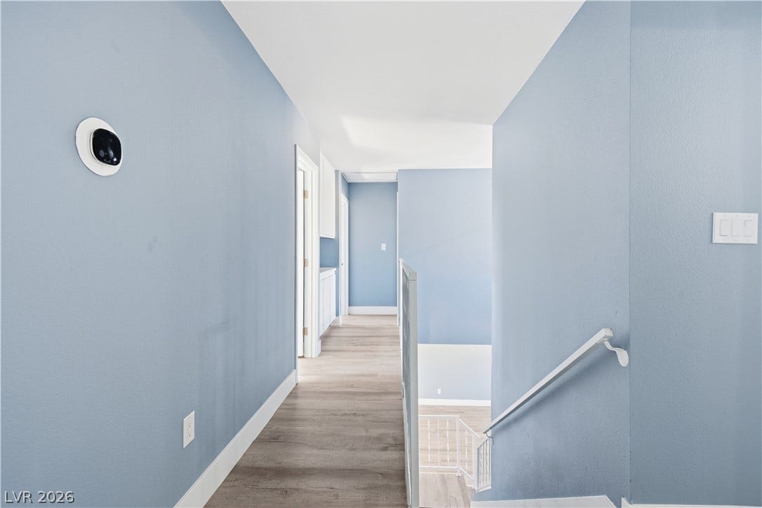 1707 Mapleton Lane, Las Vegas, NV 89119 Smooth wood flooring flows throughout this upper level hallway and stairwell landing.