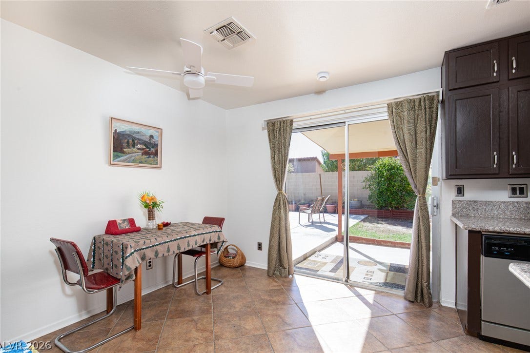 6705 Waterville Circle, Las Vegas, NV 89107 Sliding glass doors lead to the patio from this tiled dining area.