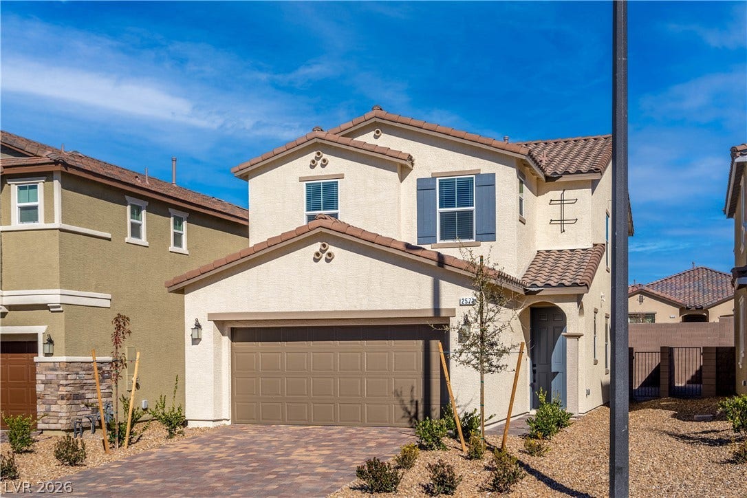 A well-maintained stucco exterior with a tiled roof offers a welcoming curb appeal